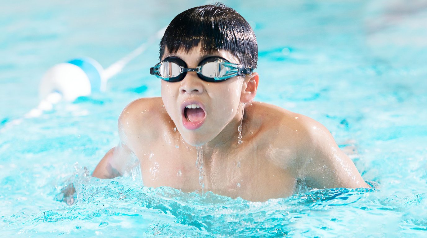 Junior swimmer breathing during breaststroke