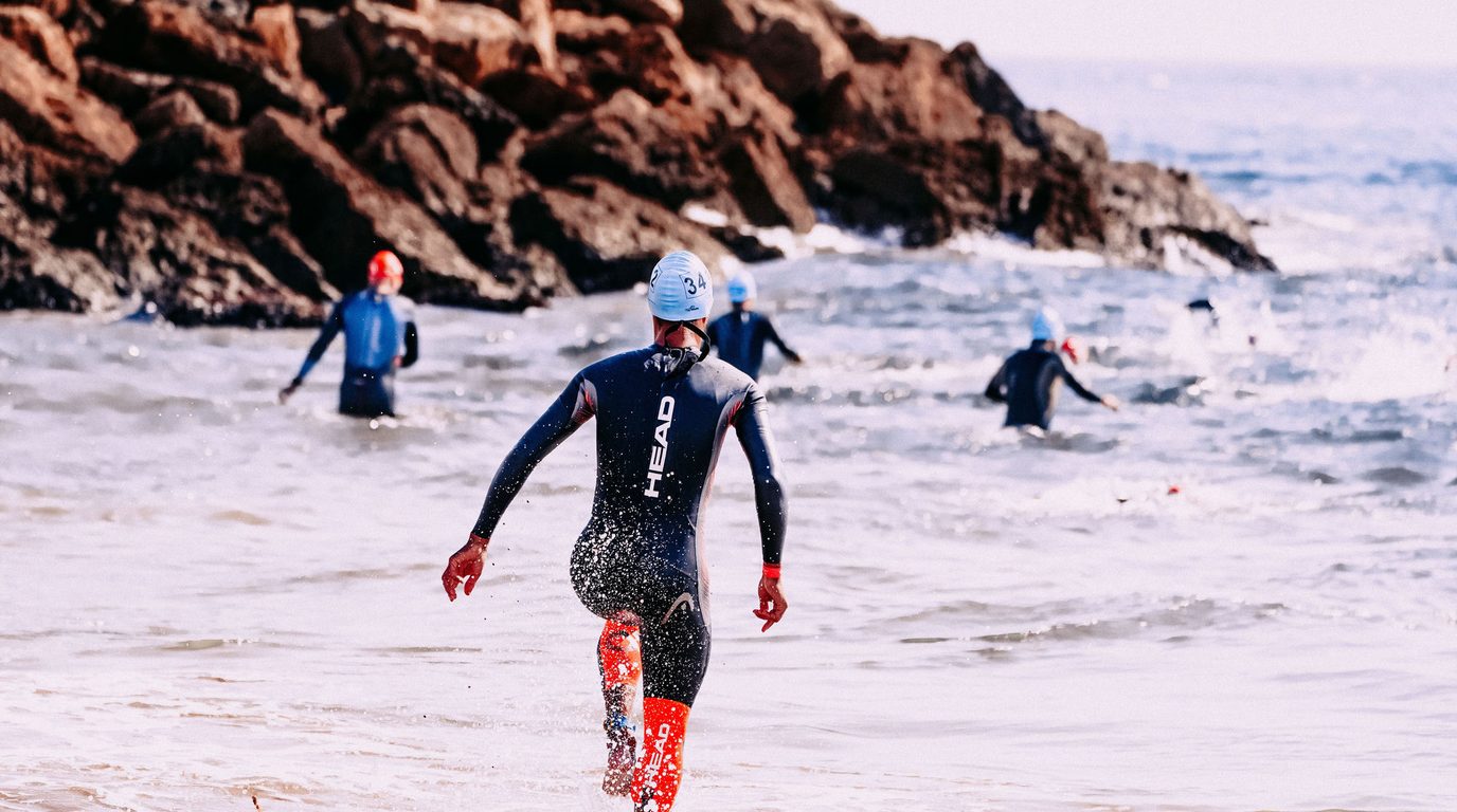 Triathlete swimming during open water swim coaching