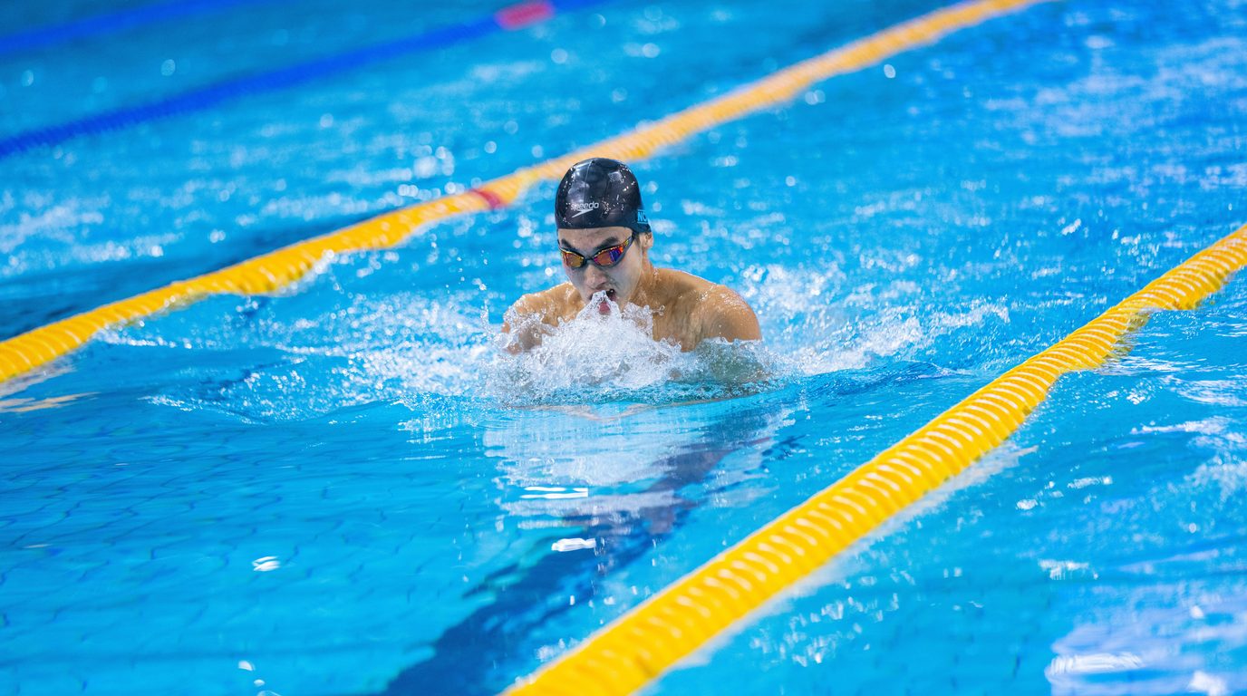 Competitive swimmer racing breaststroke